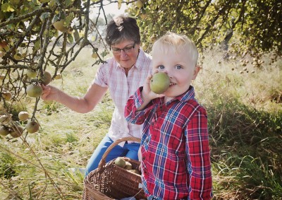 Family photo picking apples