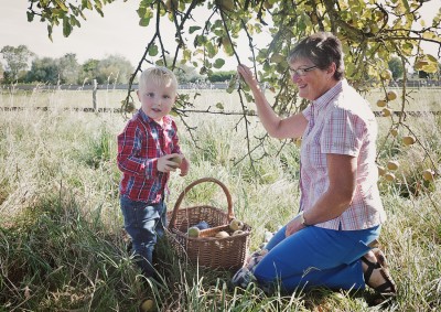 Family photo picking apples