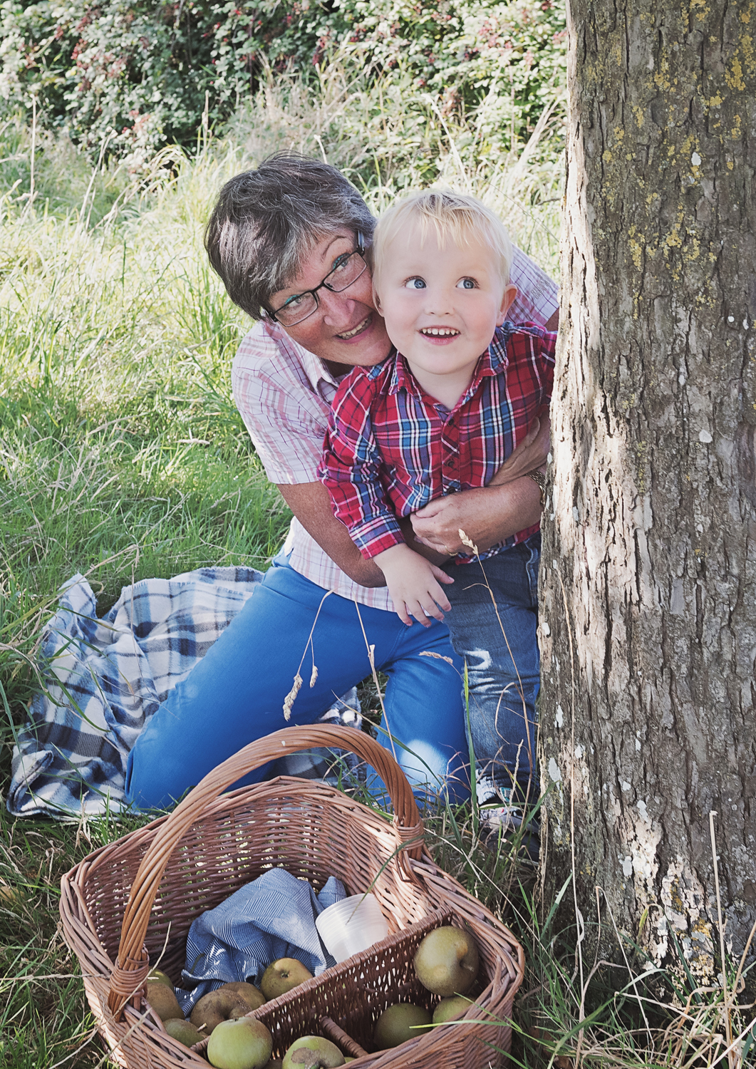 Family photo picking apples